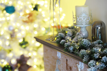 Elegant Holiday Mantel Decor with Lit Christmas Tree and Festive Ornaments in Background