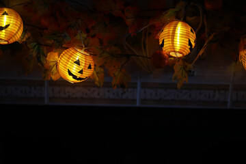 Halloween Lanterns Amidst Autumn Leaves Illuminating a Dark Background