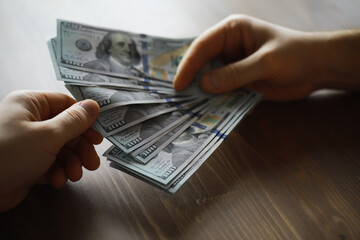 Hands Exchanging US Dollar Bills on Wooden Table - Financial Transaction, Cash Payment, Money...