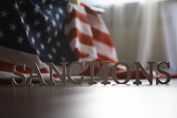 Sanctions Concept with USA Flag in the Background Representing National and International Economic...