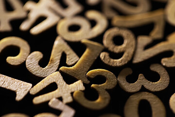 Close-Up of Vintage Golden Numbers in Random Pile - Abstract and Textured Design Element for...