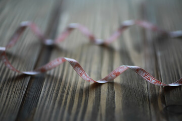 Curved Measuring Tape on Wooden Background - Measurement, Fabrication, Crafts