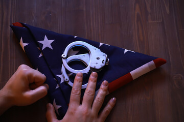 Handcuffs on Folded American Flag: Symbolism of Justice and Freedom in USA