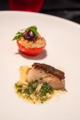 Gourmet Dish with Seared Fish and Tomato