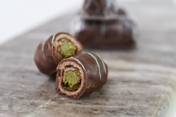 Decadent Chocolate Pistachio Rolls with green pistachio cream filling on Marble closeup side view of perfect dessert