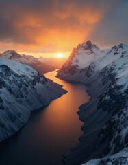 A beautiful northern landscape at sunset, with snow-covered mountains and a lake.