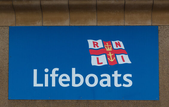 The sign and logo of charity  Royal National Lifeboat Institution known as RNLI which provides a volunteer service to rescue those in peril on the sea