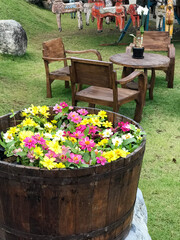 Garden Seating Area with Colorful Barrel Flowers