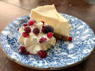 Cheesecake Slice with Berries on Floral Plate