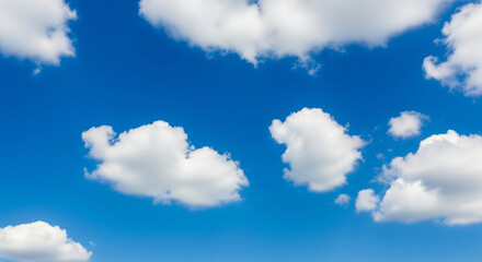 Obraz premium Natural blue sky with soft white clouds in daylight, featuring authentic cloud formations and clean atmosphere, ideal for backgrounds, weather visuals, or serene outdoor scenes