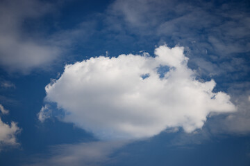 White cumulus cloud floating in deep blue sky