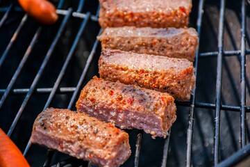 Grilled spicy sausages on a barbecue grill. Perfect for food blogs, summer BBQ invitations, restaurant ads, and cooking-related print or digital content.