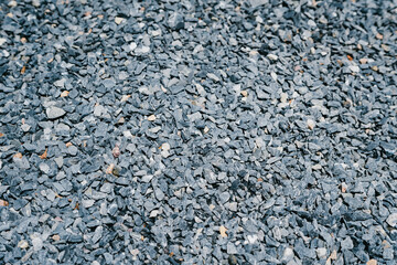 Close-Up View of Dark Gray Crushed Stones for Construction and Landscaping Purposes in Natural...
