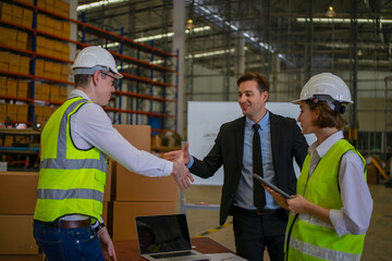 Blue collar workers are working and meeting at warehouse.