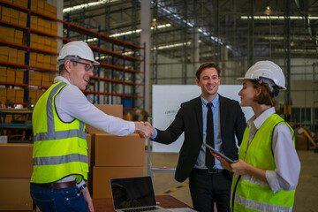 Blue collar workers are working and meeting at warehouse.