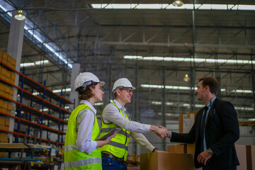 Blue collar workers are working and meeting at warehouse.