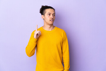 Caucasian man over isolated background thinking an idea pointing the finger up