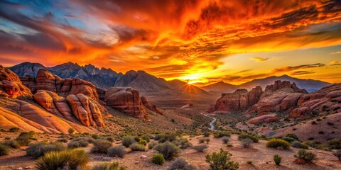 Desert sunset at Red Rock Canyon with vibrant orange hues and silhouetted rock formations in the distance, sunset