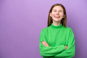 Young English woman isolated on purple background keeping the arms crossed in frontal position