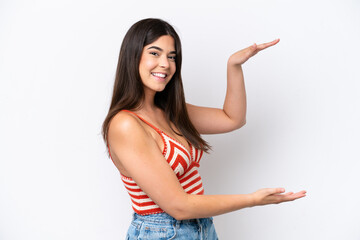 Young Brazilian woman isolated on white background holding copyspace to insert an ad