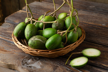 Fresh green kedondong fruits also known as ambarella arranged on a white background