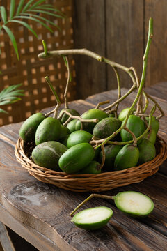 Fresh green kedondong fruits also known as ambarella arranged on a white background
