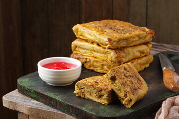 Close up of savory Malaysian murtabak filled with minced beef and chicken served as traditional street food on a plate