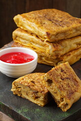 Close up of savory Malaysian murtabak filled with minced beef and chicken served as traditional street food on a plate
