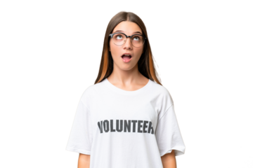 Teenager volunteer caucasian girl over isolated background looking up and with surprised expression