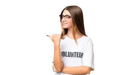 Teenager volunteer caucasian girl over isolated background pointing to the side to present a product