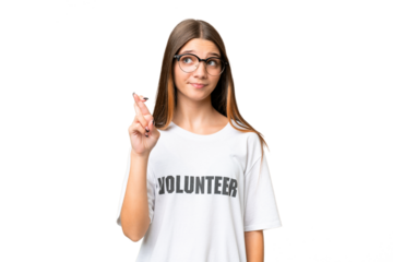 Teenager volunteer caucasian girl over isolated background with fingers crossing and wishing the best