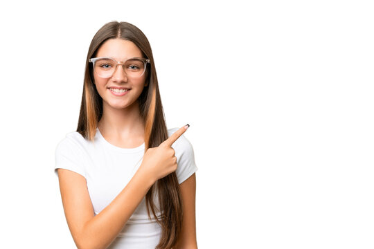 Teenager caucasian girl over isolated background pointing to the side to present a product