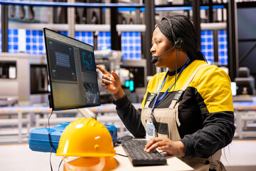 Female engineer supervises production line, using automation system to enhance conveyor belt speed...