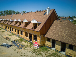 Aerial, drone view of a newly constructed building with a sloping roof and panel technology, the construction of ecological buildings.