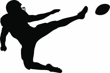 Silhouette of a football player kicking a football with dynamic leg extension.