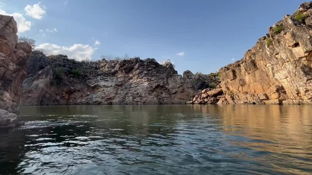 Tranquil boating scene at Bhedaghat during sunset, featuring serene waters, marble cliffs, and the golden glow of dusk.