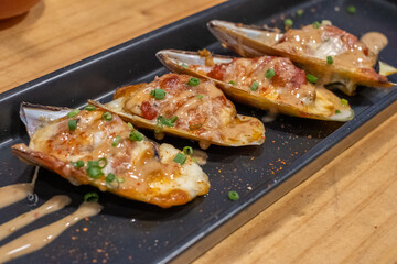 Baked Mussels on Black Serving Plate