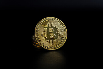 Close up of a shiny Bitcoin BTC Cryptocurrency Coin on a black background. Stock Market Concept.
