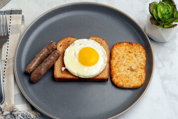 fried egg on toast  with breakfast links