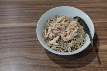 a bowl of delicious halal chicken noodles with shredded free-range chicken and springy 