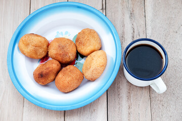 A plate of Misro, a traditional Indonesian fried cassava cake filled with sweet palm sugar, perfect for an afternoon snack or breakfast. Serve on vintage enamel plate