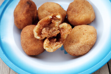 A plate of Misro, a traditional Indonesian fried cassava cake filled with sweet palm sugar, perfect for an afternoon snack or breakfast. Serve on vintage enamel plate