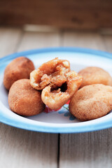 A plate of Misro, a traditional Indonesian fried cassava cake filled with sweet palm sugar, perfect for an afternoon snack or breakfast. Serve on vintage enamel plate