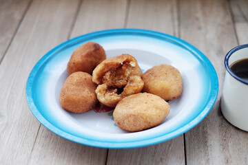 A plate of Misro, a traditional Indonesian fried cassava cake filled with sweet palm sugar, perfect...