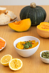  Creamy pumpkin hummus with fresh herbs and chopped vegetables. Healthy food concept.