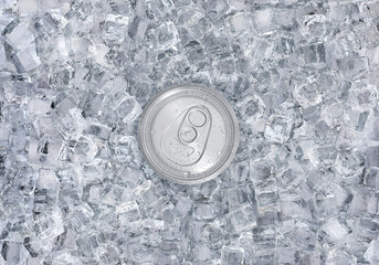 Top view. Aluminum soda can with water drops on ice cubes. Summer refreshing drink