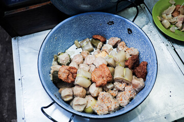 A vibrant mix of Indonesian siomay, tofu, and pig skin, steamed and ready to be enjoyed from a street food stall – a delicious blend of Chinese and Indonesian culinary traditions