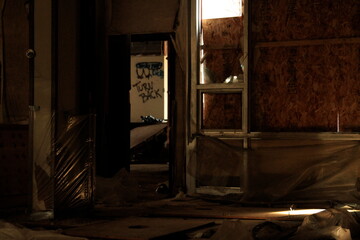Graffiti in abandoned building with boarded up windows