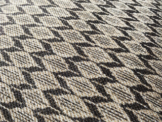 This close-up captures the intricate weave of a fabric adorned with a bold geometric pattern, where...
