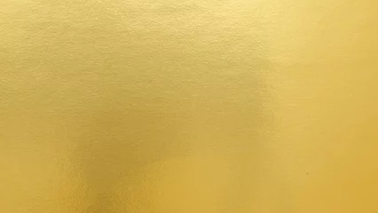 Fotobehang Goud Gradation gold foil leaf shiny matt with sparkle yellow metallic texture background. Abstract paper glitter golden glossy for template. top view.  © MAITREE